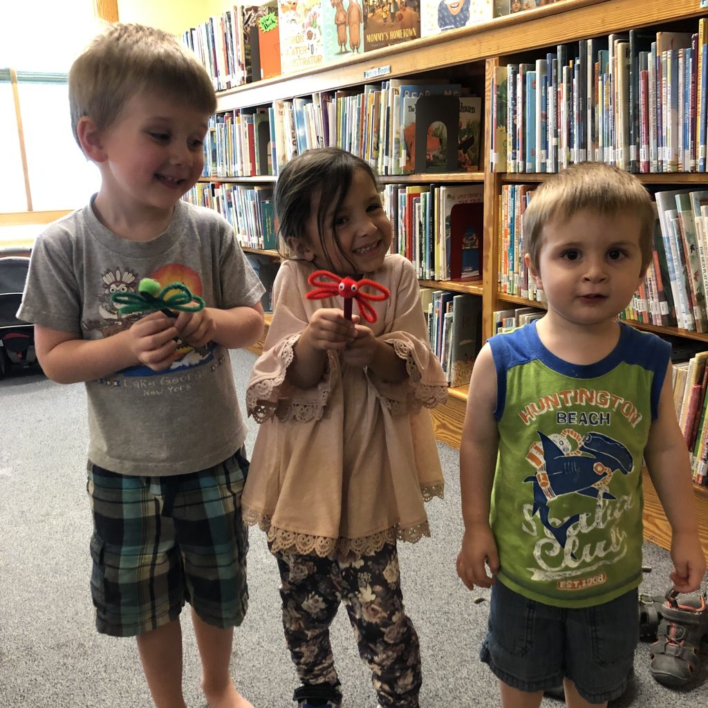 Kids with the crafts that they made at our summer reading program.
