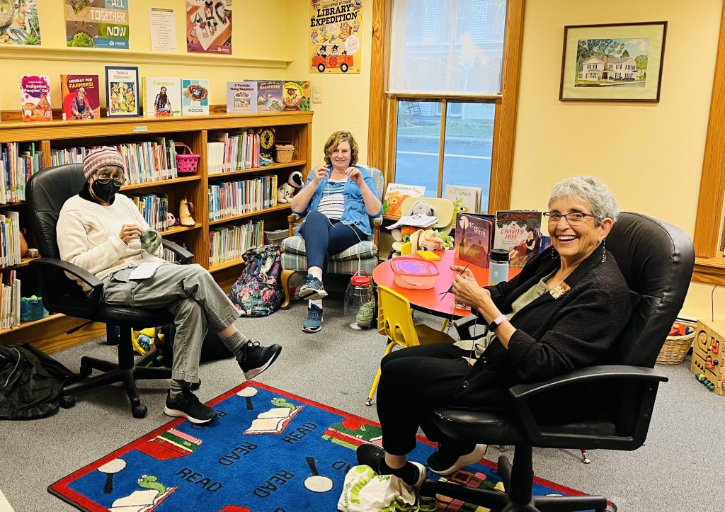 Stitch group knitting together. 